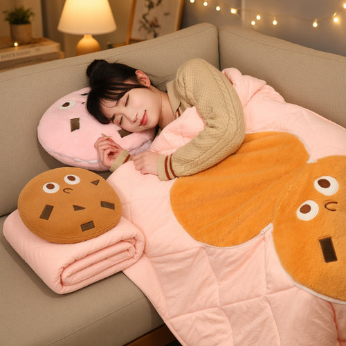 Cookie pillow blanket unfolded over a person napping on a sofa